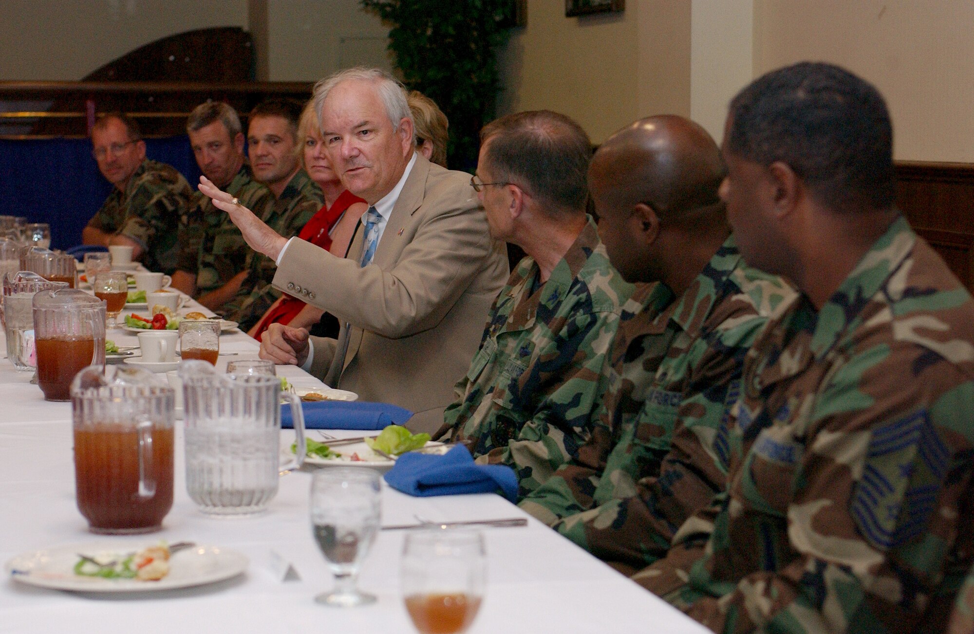 Secretary of the Air Force Michael W. Wynne speaks with chief master sergeants and first sergeants during lunch at the Galaxy Club July 18 during his visit to RAF Mildenhall, England.  It was the secretary's first visit to the base since assuming his post in 2005. While here, Secretary Wynne had the opportunity to learn about base-level issues and interface directly with Airmen.  (U.S. Air Force photo by Tech Sgt. Jeanette Copeland)