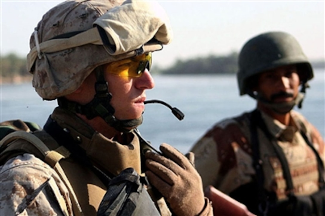 U.S. Marine Corps Cpl. Daniel Robert, 3rd Battalion, 3rd Marine Regiment, scans a portion of the Euphrates River in Barwanah, Iraq, July 29, 2006. Despite a recent rash of insurgent attacks, Marines with the mobile assault platoon say they are making notable progress equipping the Iraqi Army with the necessary skills to take over security operations in this city of 30,000 nestled along the Euphrates River northwest of Baghdad. 