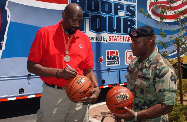 Retired NBA All-Star and Olympic gold medalist Spencer Haywood signs a basketball for Col. Gerald Curry, 99th Security Forces Group commander, Nellis Air Force Base, Nev. Mr Haywood and other former NBA players visited Nellis Aug. 1 to sign autographs and meet the troops as part of a Team USA baseketball tour. (U.S. Air Force Photo/Staff Sgt. Kenny Kennemer)
