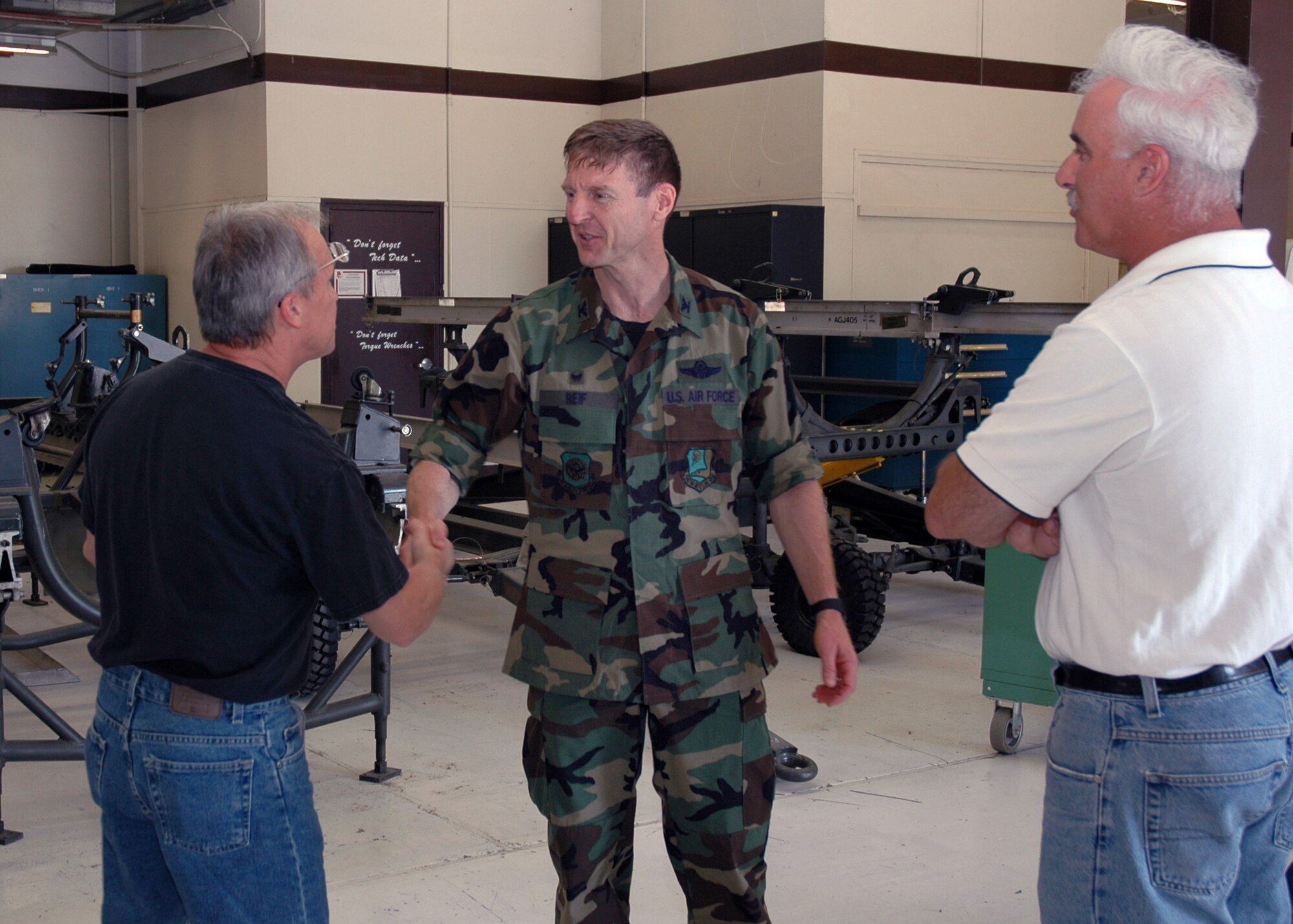 Col. Albert Reif (center), acting commander of the Air Force Reserve's 940th Air Refueling Wing at Beale Air Force Base, Calif., visits Airmen from the 940th Maintenance Group Aug. 3, 2006. Pictured left to right, Senior Master Sgt. Joseph Schmid, 940th Maintenance Squadron Propulsion Flight chief, Colonel Reif, and Senior Master Sgt. Stuart Bisland, 940th Aircraft Maintenance Squadron Air Reserve Technician. Colonel Reif will assume full command of the 940 ARW during an assumption of command ceremony in September.  (U.S. Air Force Photo/Stacey Knott)