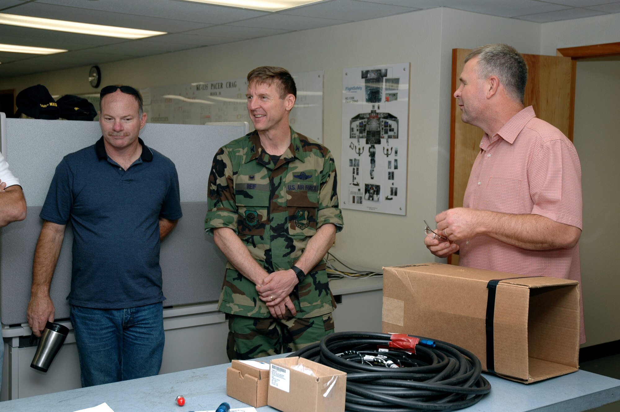Col. Albert Reif (center), acting commander of the Air Force Reserve's 940th Air Refueling Wing at Beale Air Force Base, Calif., talks with Airmen from the 940th Maintenance Group Aug. 3, 2006. Pictured left to right, Senior Master Sgt. John Erwin, 940th  Aircraft Maintenance Squadron Air Reserve Technician, Colonel Reif, and Master Sgt. Michael Weaver, 940 AMXS, Avionics Branch cheif.  Colonel Reif will assume full command of the 940 ARW during an assumption of command ceremony in September.  (U.S. Air Force Photo/Stacey Knott)
