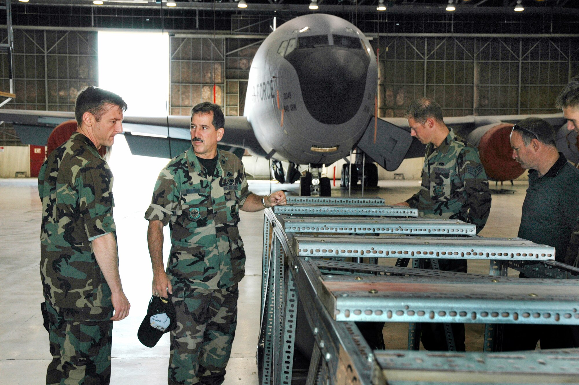 Col. Albert Reif (left), acting commander of the Air Force Reserve's 940th Air Refueling Wing at Beale Air Force Base, Calif., looks at a crated KC-135T part with troops from the 940th Maintenance Group Aug. 3, 2006.  Pictured left to right, Colonel Reif, Col. Sonny Giddings, 940th MXG commander, Staff Sgt. James Bode, 940th Aircraft Maintenance Squadron crew chief, and Senior Master Sgt. John Erwin, 940 AMXS Air Reserve Technician.  Colonel Reif will assume full command of the 940 ARW during an assumption of command ceremony in September. (U.S. Air Force Photo/Stacey Knott)
