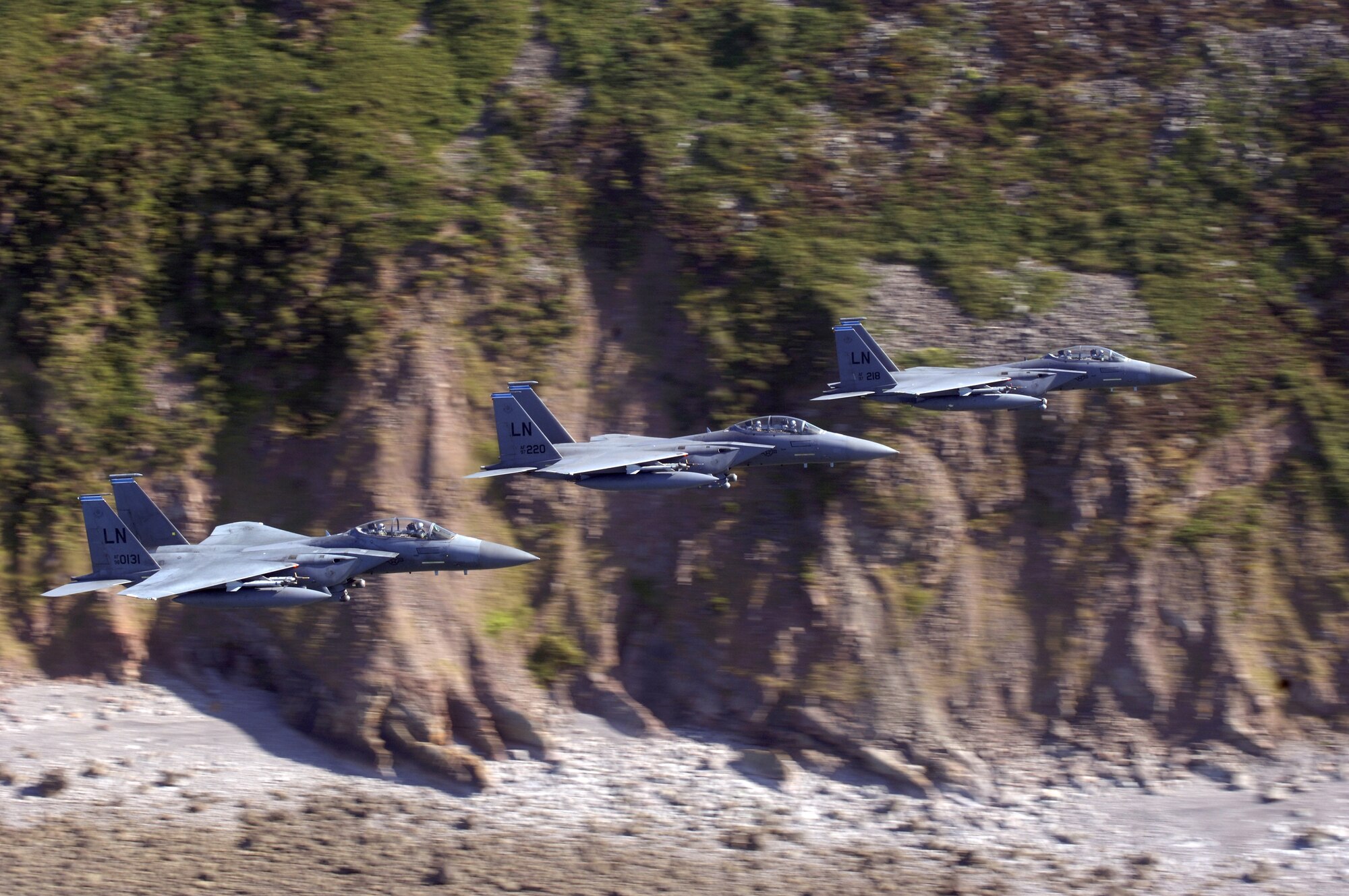 Three F-15E Strike Eagles from the 492nd Fighter Squadron at Royal Air Force Lakenheath, England, cruise at 300 mph along the cliffs of the southwestern English coast.  The aircrews were on the way to an area off the coast where they could practice basic surface attack techniques.  (U.S. Air Force photo/Master Sgt. Lance Cheung)