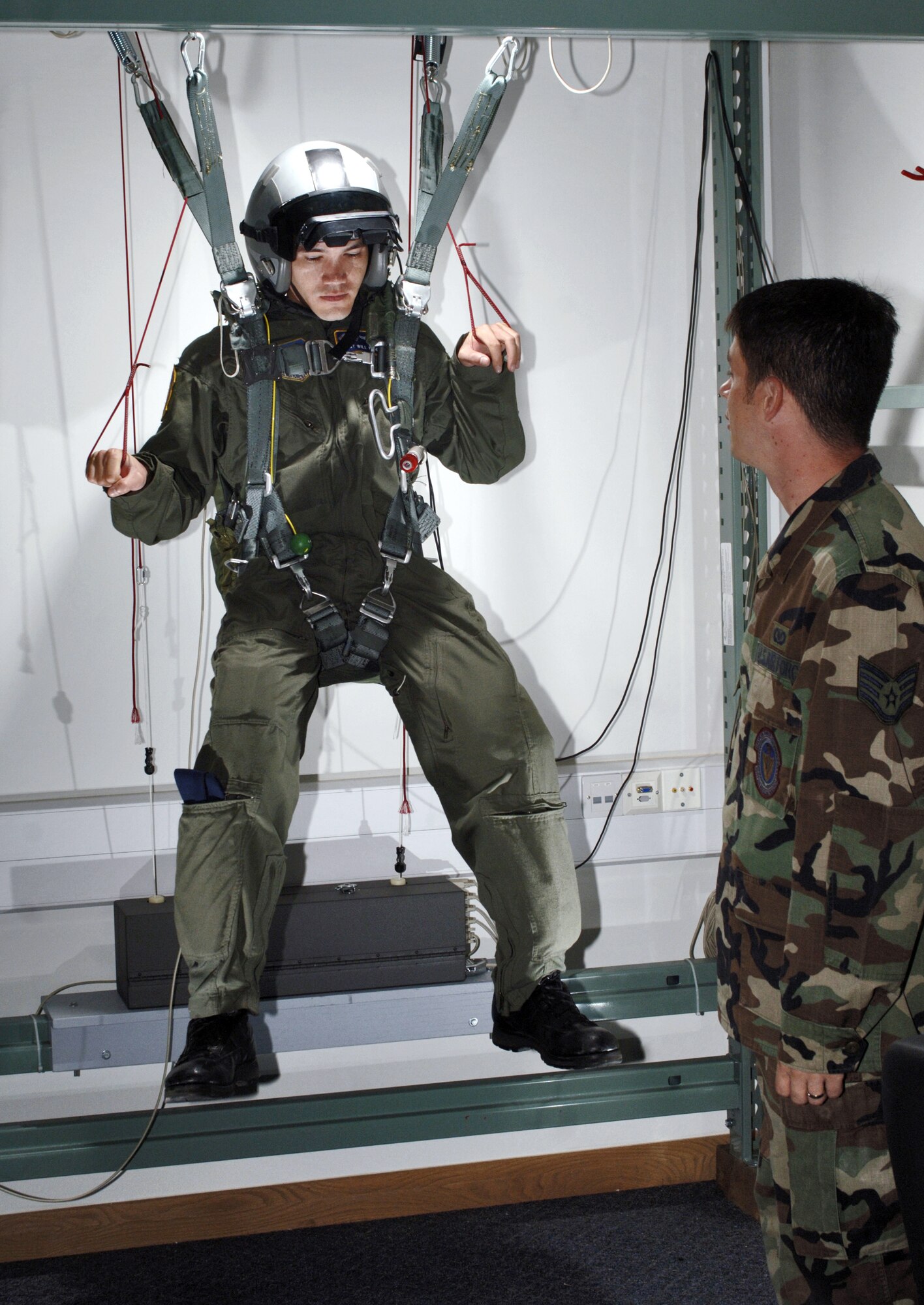 Staff Sgt. Will Perdew practices his parachute control with instruction from Staff Sgt.Alan Pratt during a training session in the life support facility at Royal Air Force Mildenhall, England, on Thursday, Aug. 3.  Sergeant Pratt is an aircrew life support specialist with the 100th Operations Support Squadron.  Sergeant Perdew is a KC-135 Stratotanker boom operator with the 351st Air Refueling Squadron.  (U.S. Air Force photo/Master Sgt. Lance Cheung)