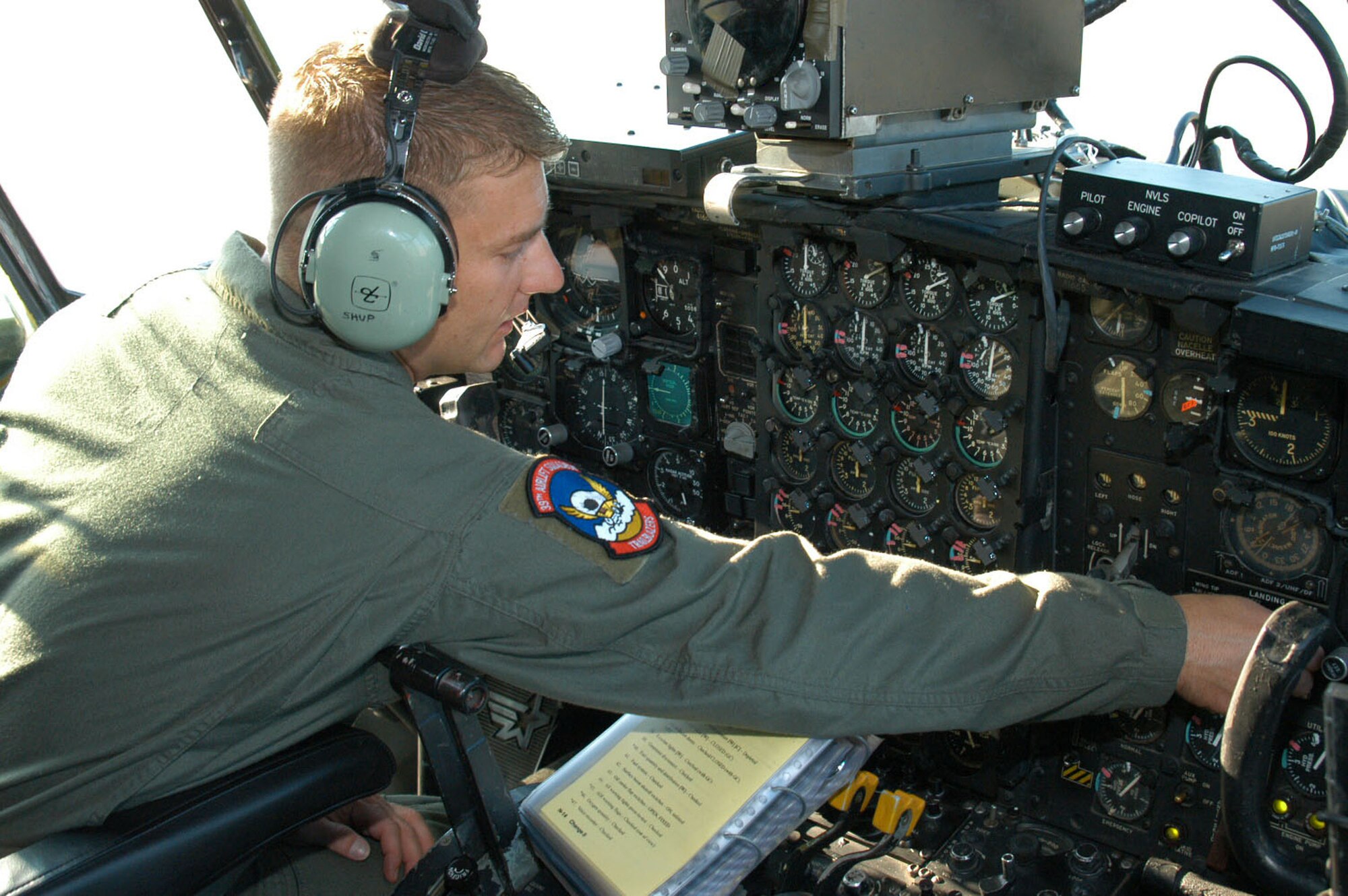 Staff Sgt. Shannon Shuping, 317th AG flight engineer, performs pre-flight checks in the cockpit.