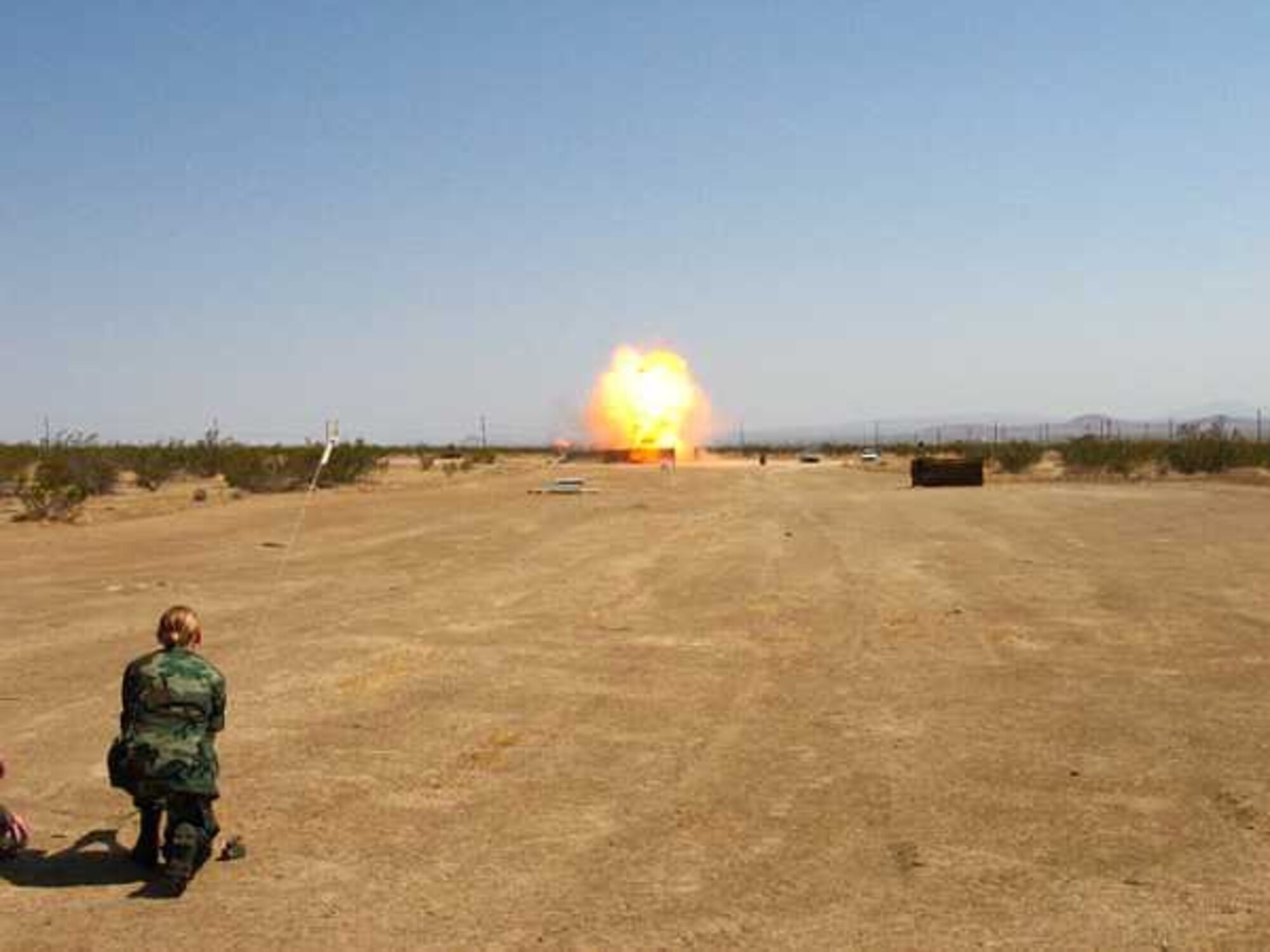 EDWARDS AIR FORCE BASE, Calif. — Civil Air Patrol Airman 1st Class Jessica Waldrop detonates 5 pounds of C-4 explosive at the Explosive Ordnance Disposal Division’s range here during Civil Air Patrol Cadet Week July 26 through 29. (Civil Air Patrol photo by Maj. Jason Markiewitz)

