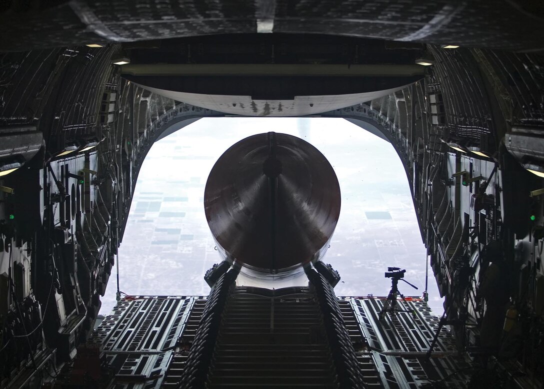 EDWARDS AIR FORCE BASE, Calif. — A 65-foot, 72,000-pound booster rocket mockup exits the cargo bay of a C-17 Globemaster III July 26. The airdrop was the final test in Phase 2B of the Falcon Small Launch Vehicle program, a joint venture between the Defense Advanced Projects Research Agency and the Air Force to develop a more flexible, low-cost method of launching a satellite into low earth orbit. The mockup is the longest and heaviest single object ever dropped from a C-17. (Air Force photo by Steve Zapka)

