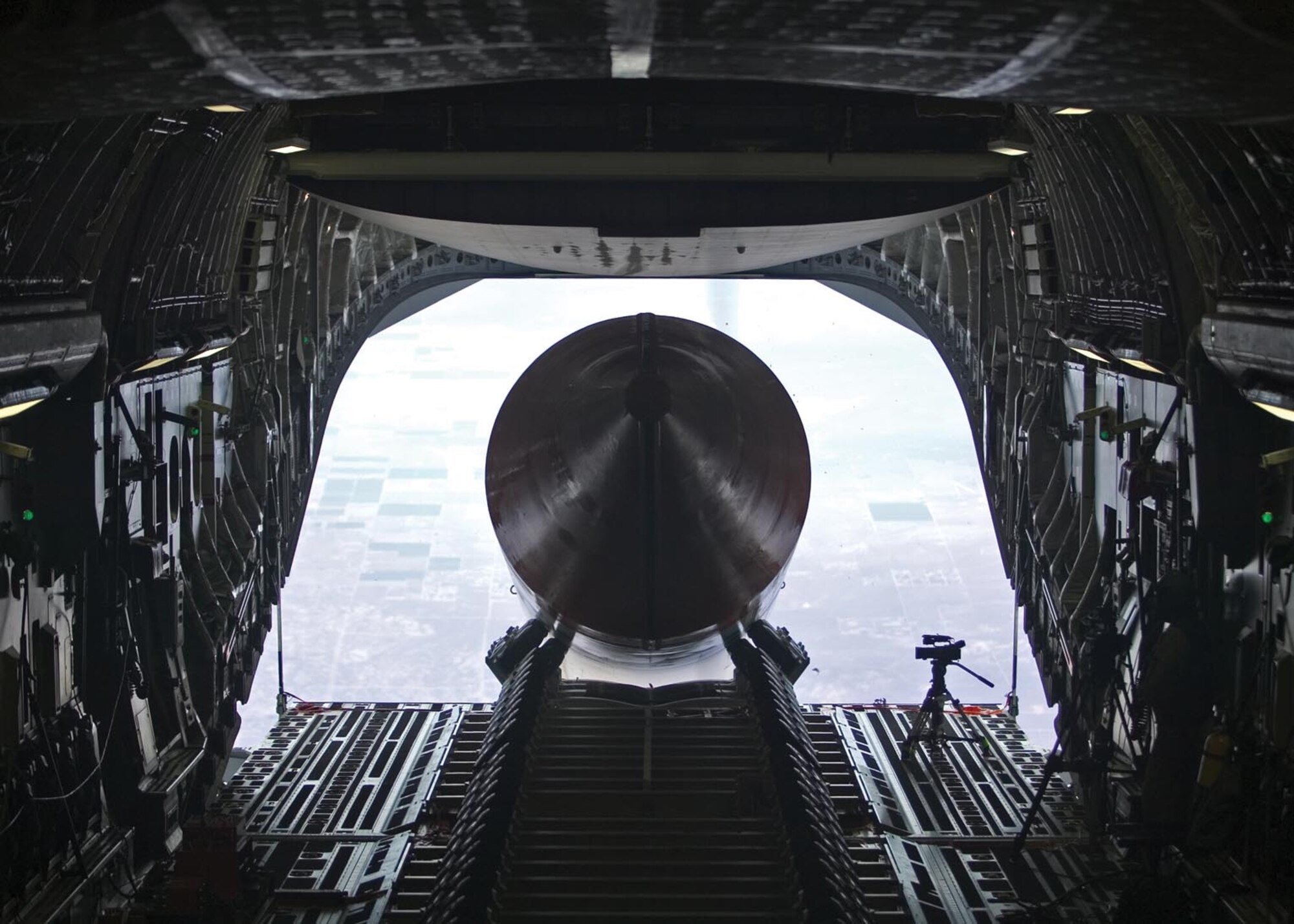 EDWARDS AIR FORCE BASE, Calif. — A 65-foot, 72,000-pound booster rocket mockup exits the cargo bay of a C-17 Globemaster III July 26. The airdrop was the final test in Phase 2B of the Falcon Small Launch Vehicle program, a joint venture between the Defense Advanced Projects Research Agency and the Air Force to develop a more flexible, low-cost method of launching a satellite into low earth orbit. The mockup is the longest and heaviest single object ever dropped from a C-17. (Air Force photo by Steve Zapka)

