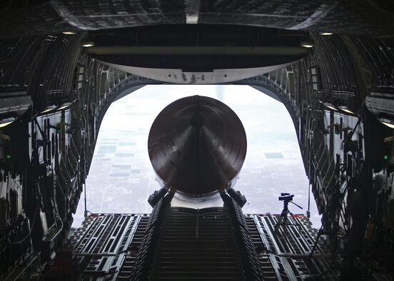 EDWARDS AIR FORCE BASE, Calif. — A 65-foot, 72,000-pound booster rocket mockup exits the cargo bay of a C-17 Globemaster III July 26. The airdrop was the final test in Phase 2B of the Falcon Small Launch Vehicle program, a joint venture between the Defense Advanced Projects Research Agency and the Air Force to develop a more flexible, low-cost method of launching a satellite into low earth orbit. The mockup is the longest and heaviest single object ever dropped from a C-17. (Air Force photo by Steve Zapka)

