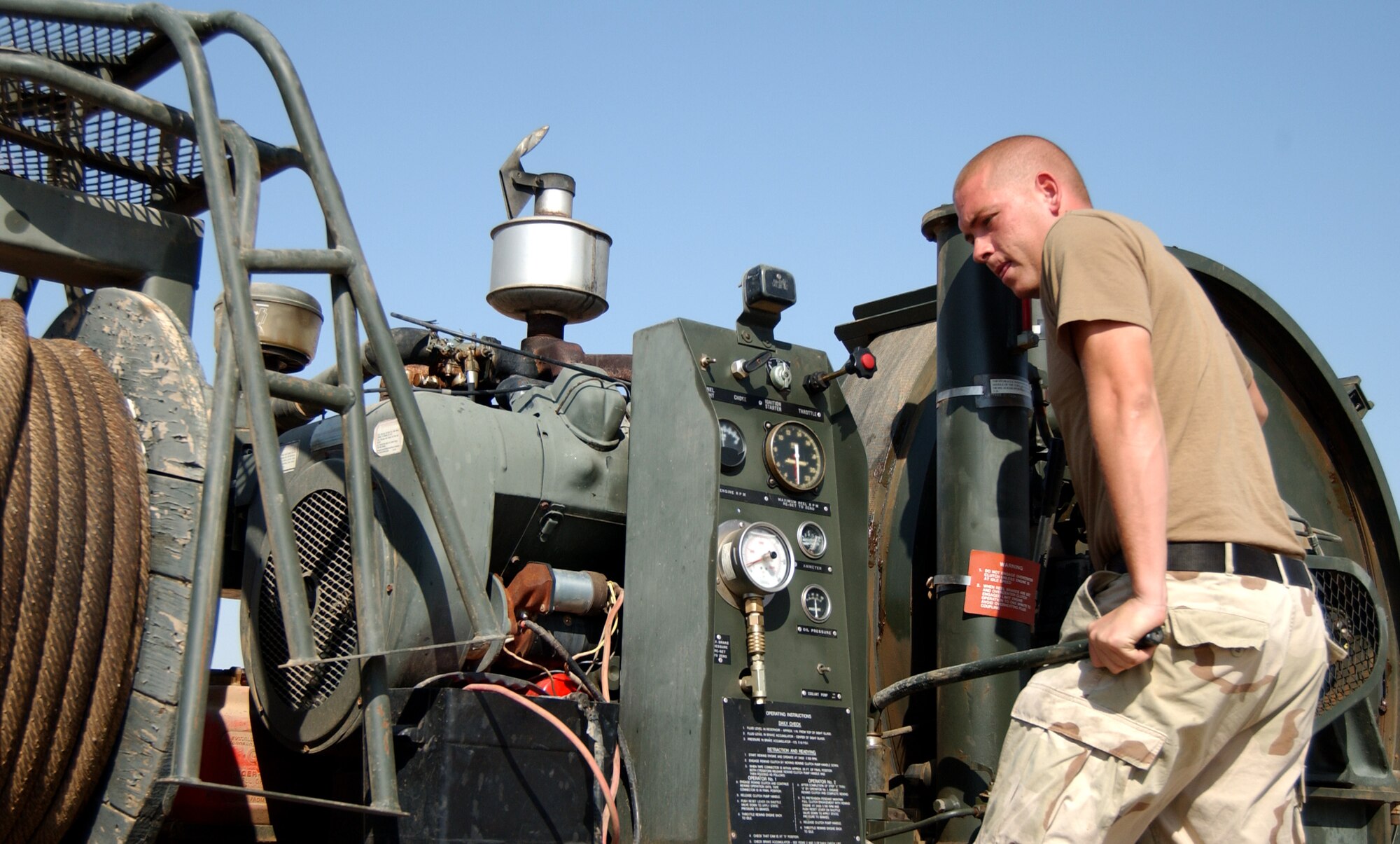 Staff Sgt. Robert Neubert performs routine maintenance on the mobile aircraft arresting system July 26 at Balad Air Base, Iraq. Sergeant Neubert is assigned to the . 332nd Air Expeditionary Civil Engineer Squadron. (U.S. Air Force photo/Senior Airman Kerry Solan-Johnson) 
