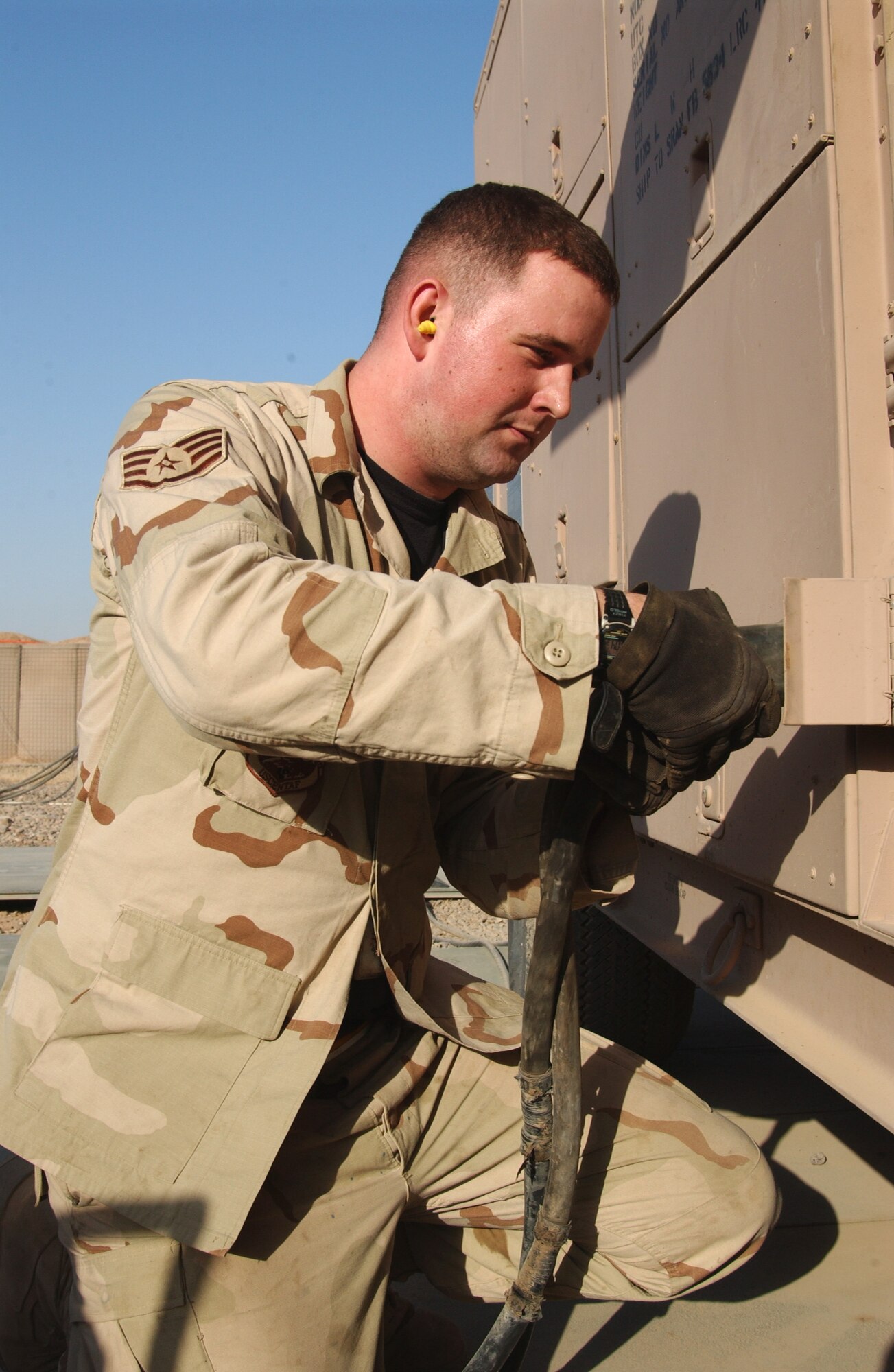 Staff Sgt. Kristopher Oyen checks one of the four generators that supply electricity to the mobile aircraft arresting system July 26 at Balad Air Base, Iraq. He is assigned to the 332nd Air Expeditionary Civil Engineer Squadron. (U.S. Air Force photo/Senior Airman Kerry Solan-Johnson) 
