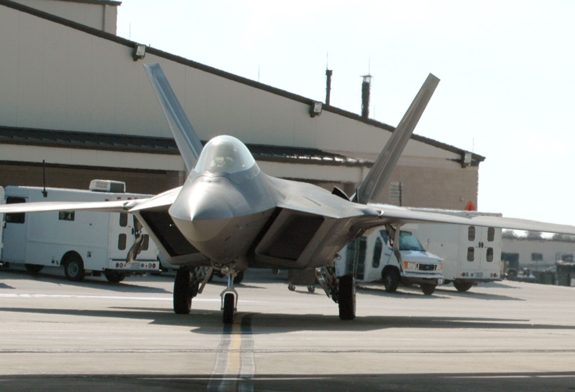 An F-22 Raptor taxis to the hangar after a mission at Tyndall Air Force Base, Fla. Command and control integration advancements with the Raptor include free text messages which can be sent by controllers to the pilots using high-speed digital data link technology. (U.S. Air Force photo/1st Lt. Jon Quinlan) 