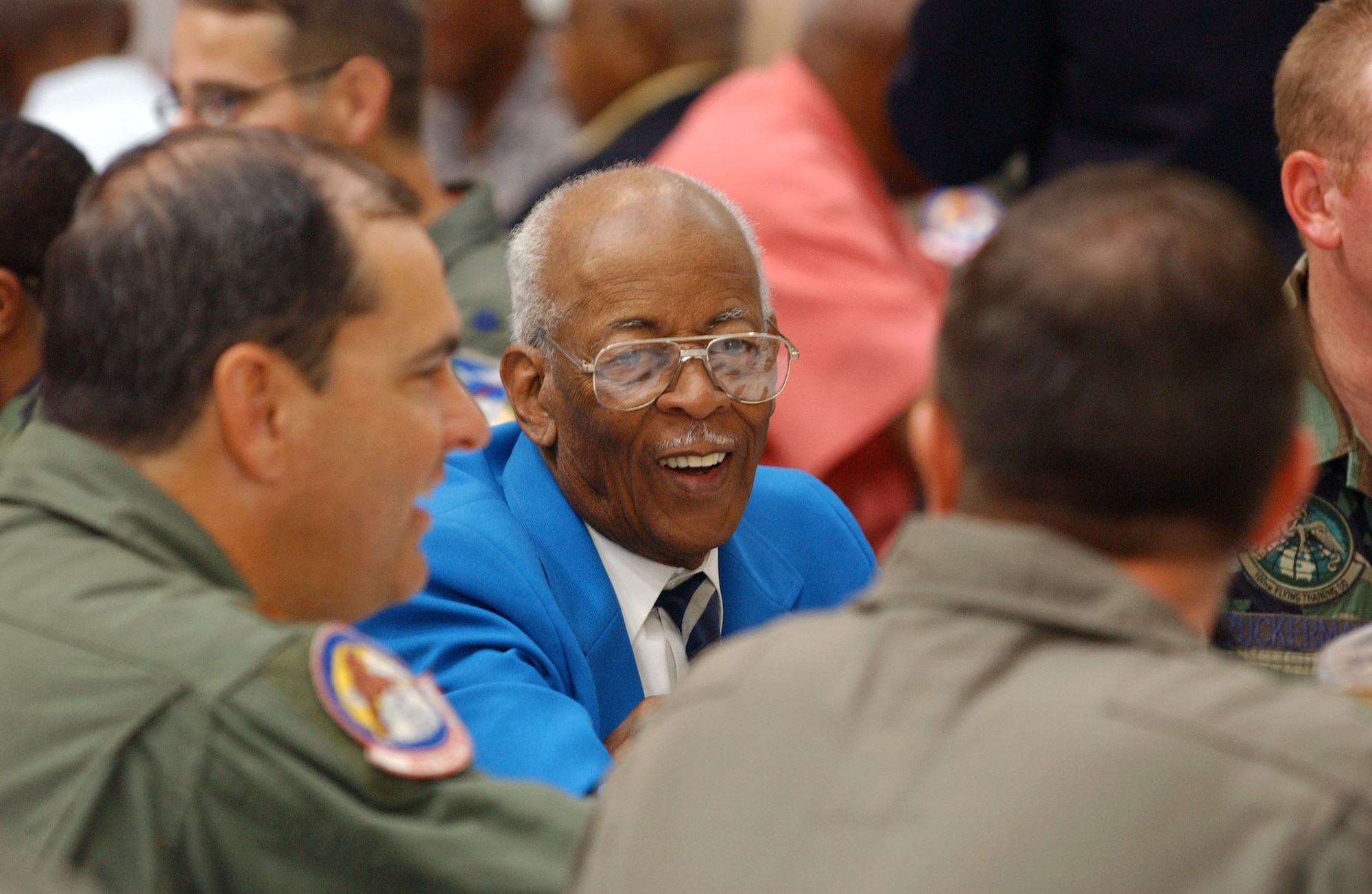 A Tuskegee Airman speaks with aviators from the 944th Fighter Wing at Luke Air Force Base, Ariz., on Aug. 2 during the Tuskegee Airmen, Inc., 35th Annual National Convention. The organization exposes minority youth to aviation and aerospace technology. (U.S. Air Force photo/Senior Airman Francisco V. Govea II)
