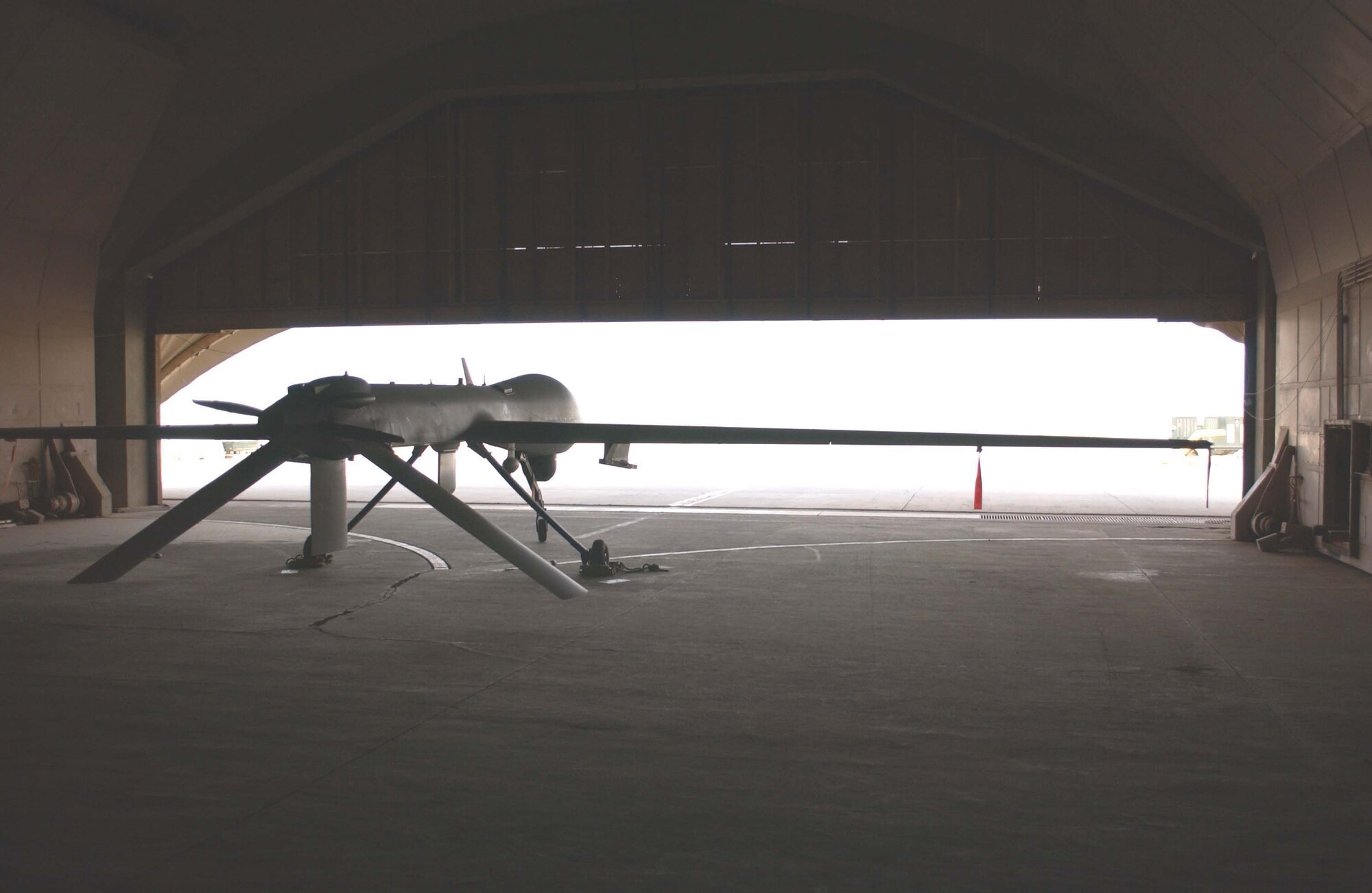 An MQ-1 Predator unmanned aerial vehicle is stored between missions in the cool space of a hardened aircraft shelter at Balad Air Base, Iraq, on July 31. With flying missions that last an average of 20 hours, Airmen from the 46th Expeditionary Reconnaissance Squadron provide ground commanders "persistant stare" by following suspected insurgent activities for long periods of time. (U.S. Air Force photo/Senior Airman Jim Croxon)