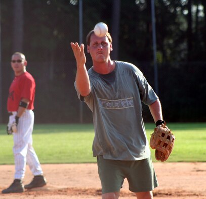 Kelvin “Chigger” Cannington, 16th Equipment Maintenance Squadron, focuses on pitching the ball Aug. 1. The win propels CES into a face-off with the 16th Communications Squadron in the next round. (U.S. Air Force Photograph by Staff Sgt. Kelly Ogden)