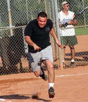 Juan Saldana, 16th Civil Engineer Squadron, sprints to first base during the intramural softball playoffs Aug. 1. The win propels CES into a face-off with the 16th Communications Squadron in the next round. (U.S. Air Force Photograph by Staff Sgt. Kelly Ogden)