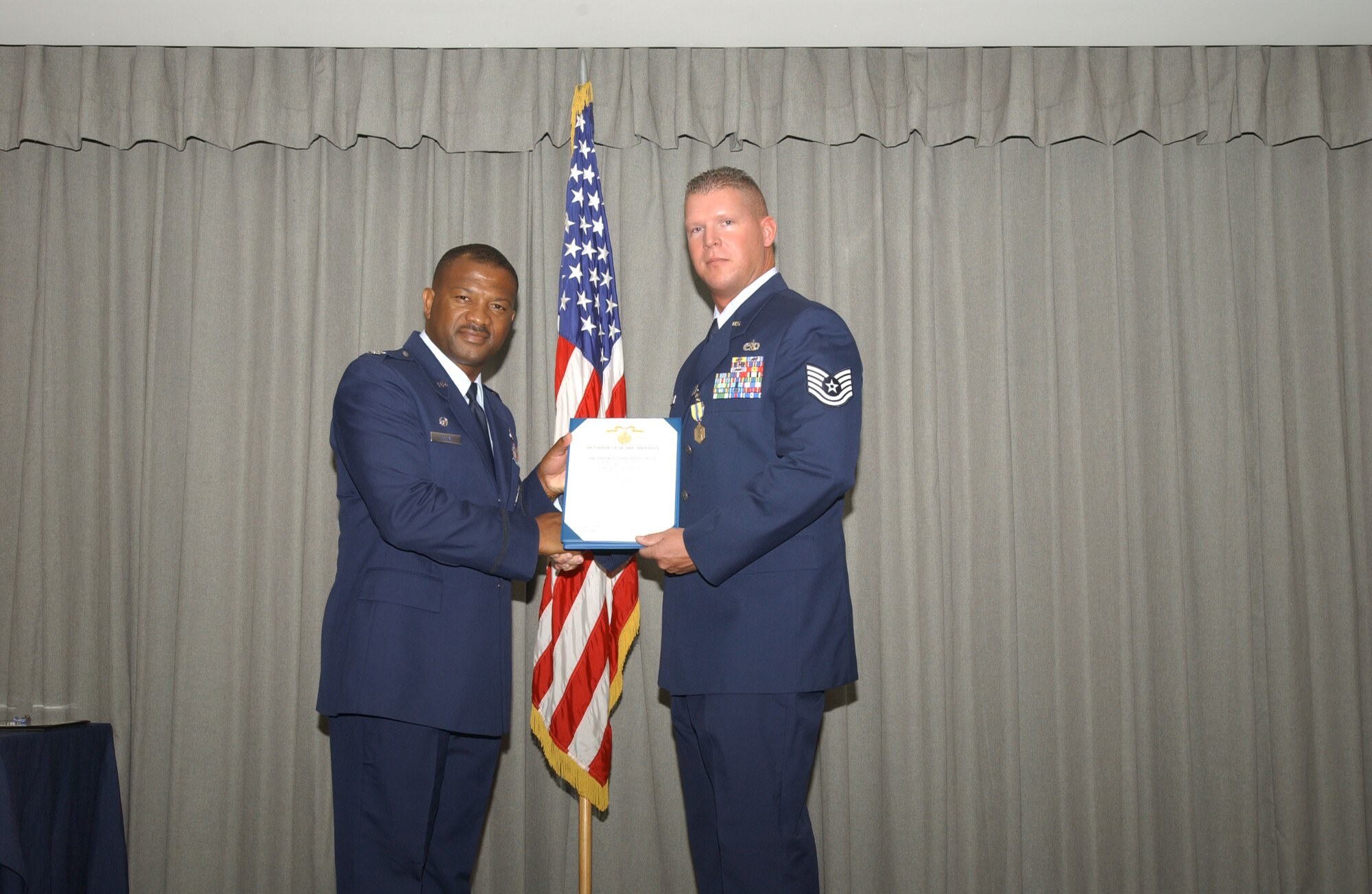 Col. Socrates Greene (left), 16th Maintenance Group commander, presents Tech. Sgt. Mark Skerrett, 16th HMXS, the Air Force Commendation medal, third oak leaf cluster with valor July 27. (U.S. Air Force Photograph by Airman 1st Class Stephanie Sinclair)