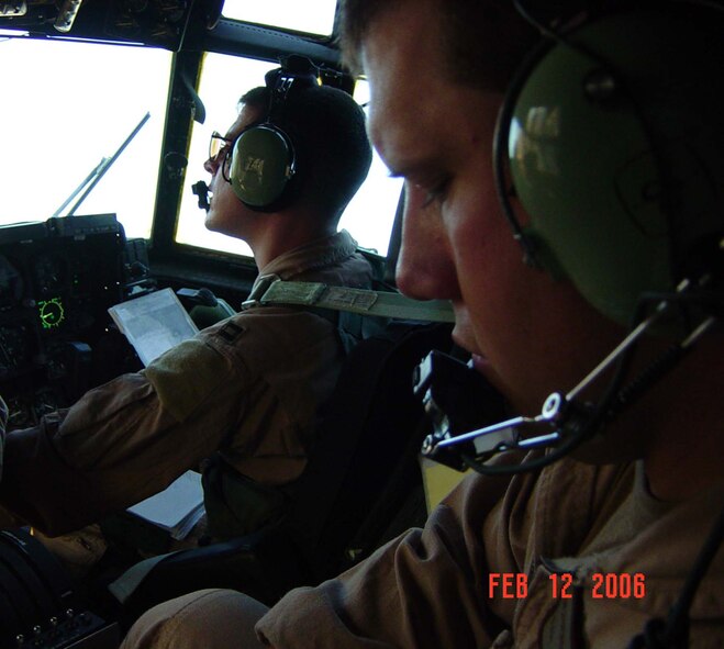 MOODY AIR BASE, Ga. -- Capt. Matt Barnes (left) and Staff Sgt. Gary Gessendorf, both from the 71st Rescue Squadron here, run through checklists during a recent deployment mission at the Horn of Africa. Airmen from the 347th Rescue Wing who deployed to this area, recorded 66 saves and 56 assists since June 1.  (U.S. Air Force courtesy photo) 