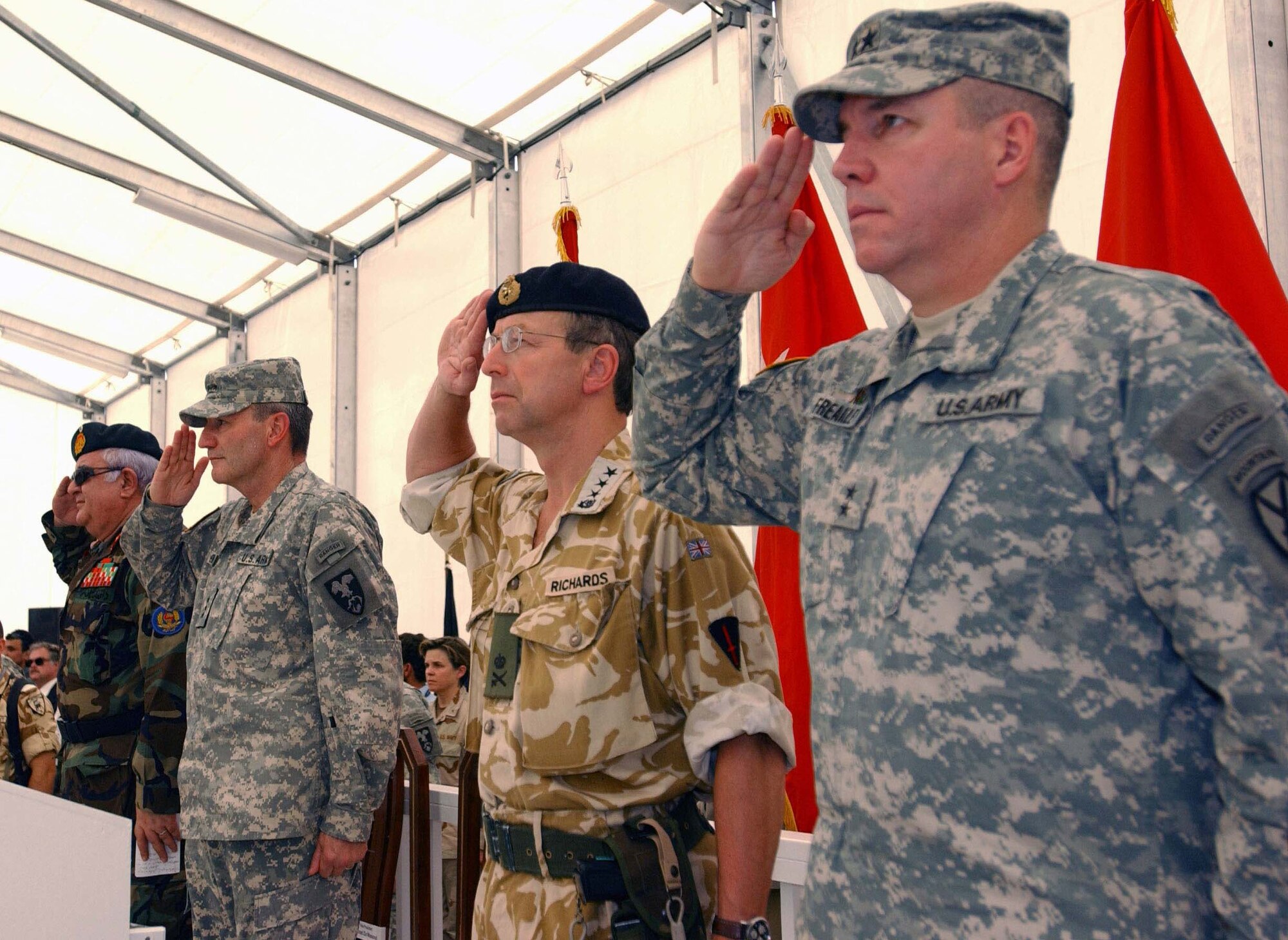 Left to right, Afghan Minister of Defense Abdul Rahim Wardak; U.S. Army Lt. Gen. Karl W. Eikenberry, Combined Forces Command - Afghanistan commander; British Lt. Gen. David Richards, International Security Assistance Force commander; and U.S. Army Maj. Gen. Benjamin C. Freakley, Combined Joint Task Force - 76 commander, salute during a transfer of authority ceremony at Kandahar Airfield, Afghanistan, July 31.  Command in southern Afghanistan was transferred from Coalition forces to NATO's ISAF during the ceremony. (US Army photo/Staff Sgt. Robert R. Ramon)