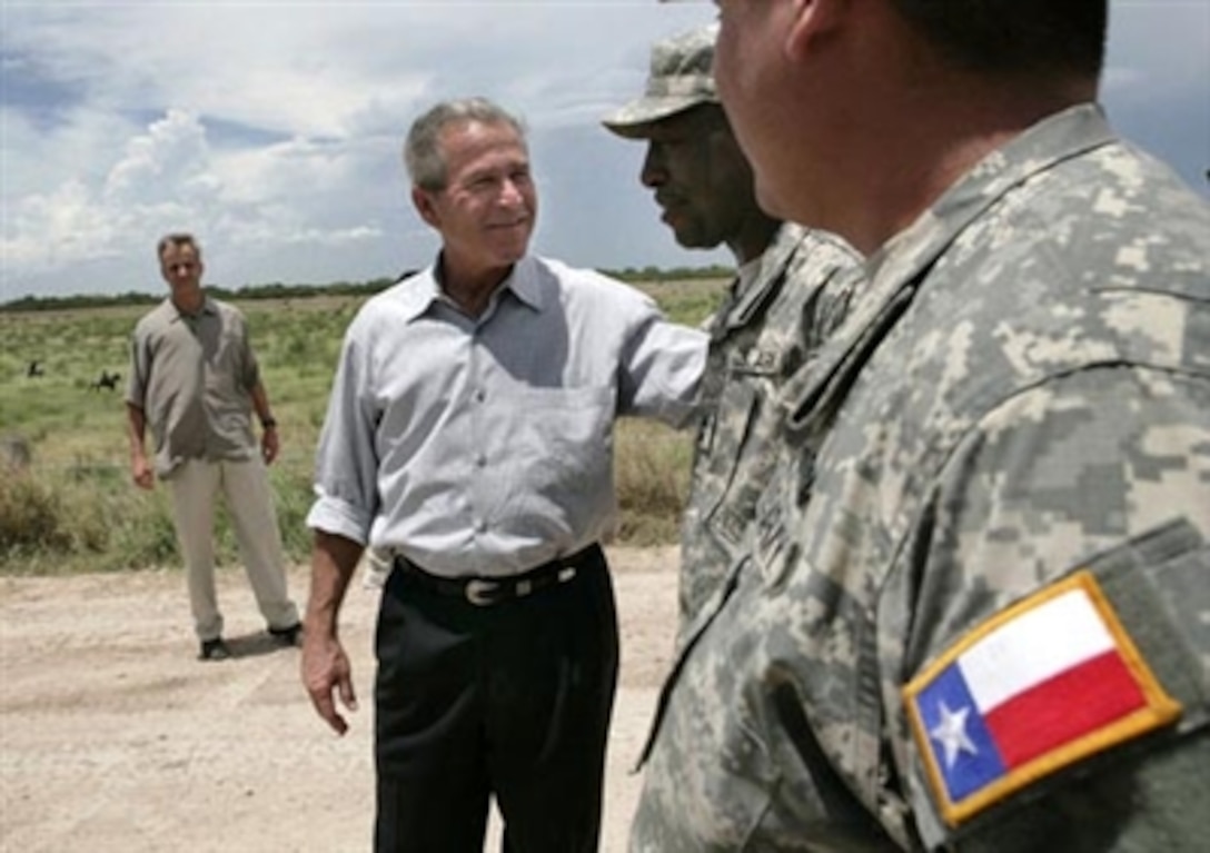 President George W. Bush speaks with members of the Army National Guard on duty along the U.S.-Mexico border during his visit  Aug. 3, 2006, in the Rio Grande Valley border patrol sector in Mission, Texas. 