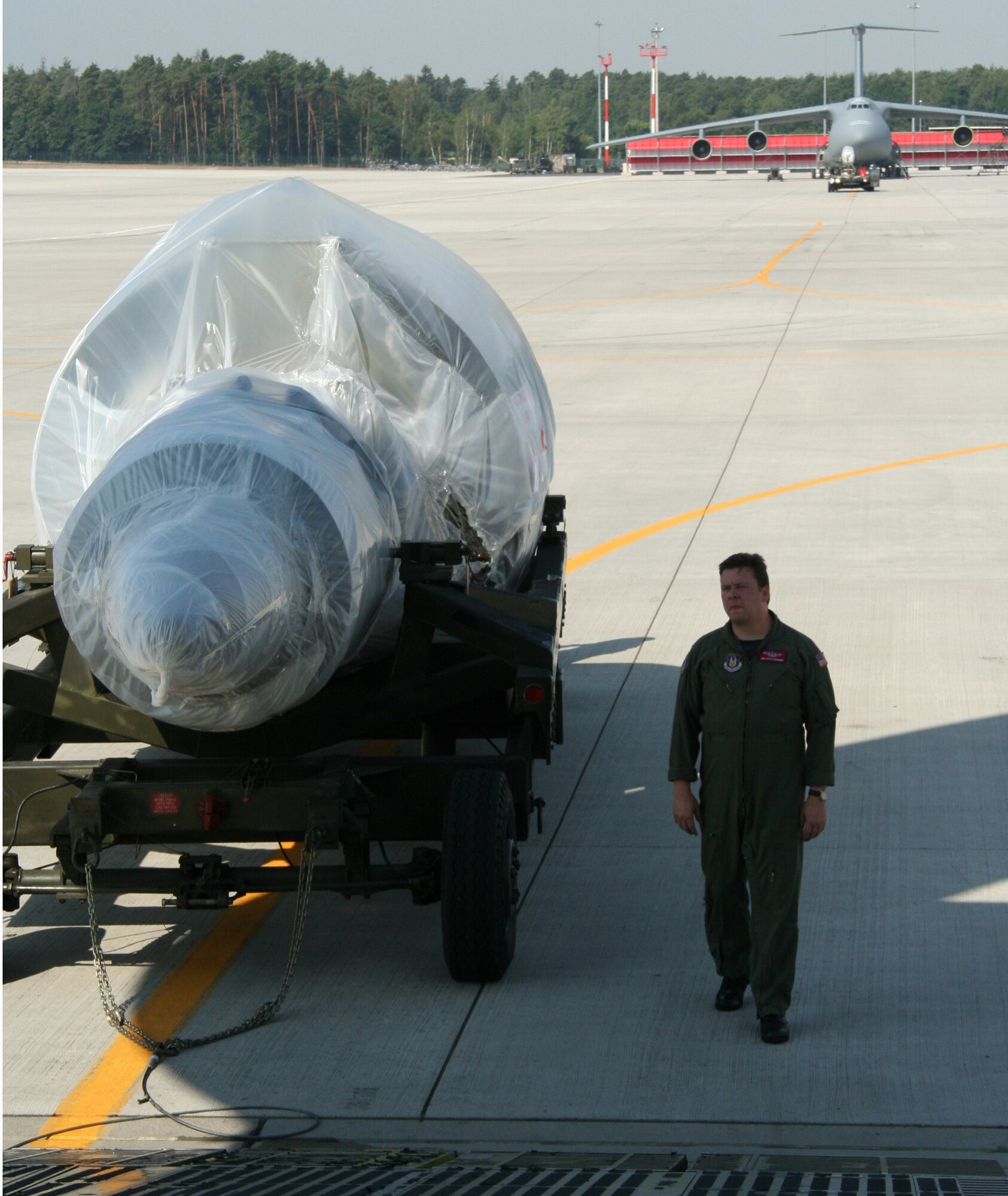 Master Sgt. Scott Naehring, 89th Airlift Squadron, prepares to load a C-5 engine onboard a C-5 at Ramstein AB, Germany. The 89th flew the engine, along with nearly 65,000 pounds of cargo, to Dover AFB during the first C-5 mission for Wright-Patterson AFB. (U.S. Air Force Reserve photo by Senior Airman Martin Moleski.)