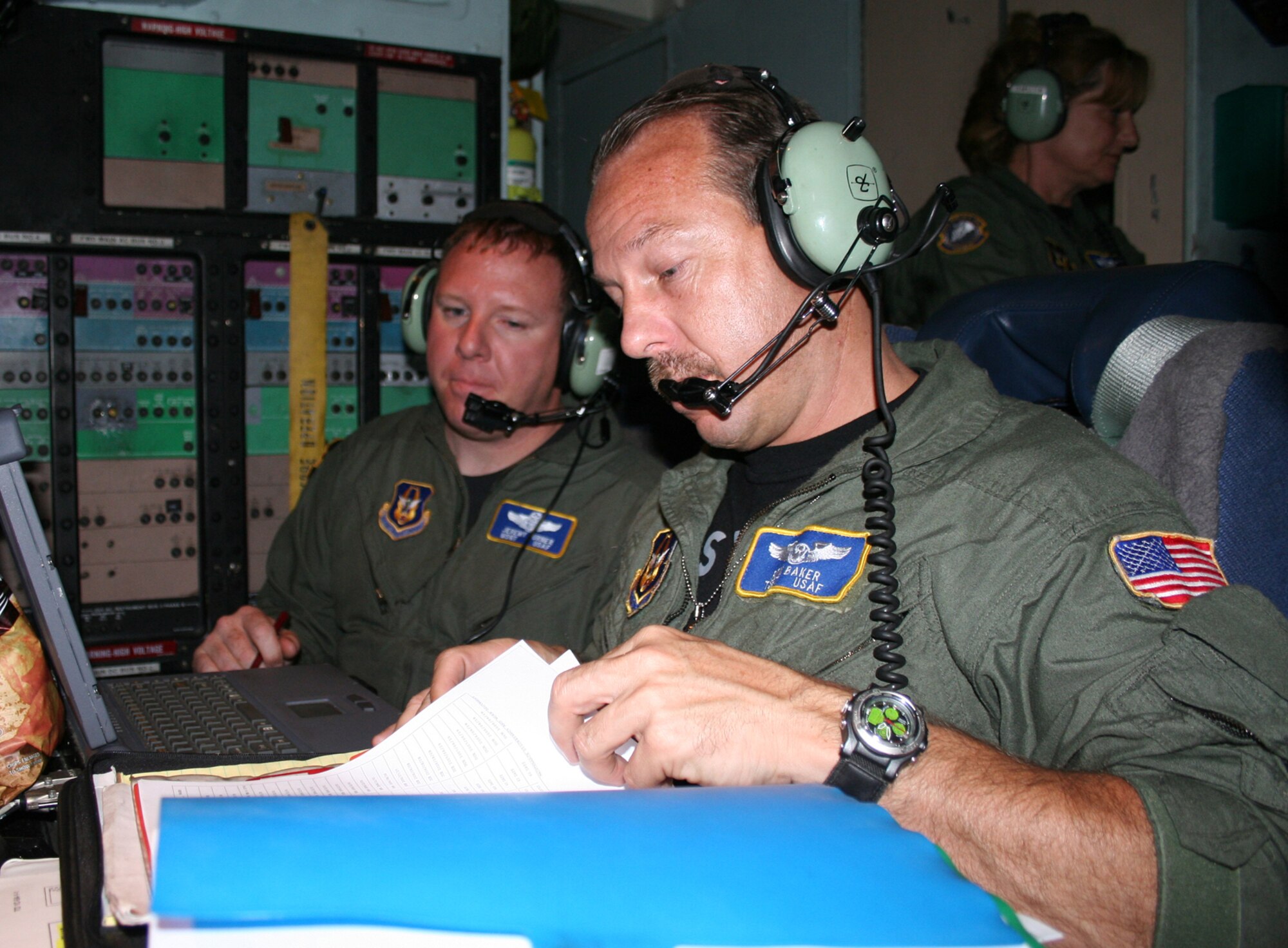 Tech. Sgt. Ron Baker (right) and Master Sgt. Jeremy Turner look through in-flight instructions aboard the first C-5 mission for the 89th Airlift Squadron stationed at Wright-Patterson AFB, Ohio. (U.S. Air Force Reserve photo by Senior Airman Martin Moleski.)
