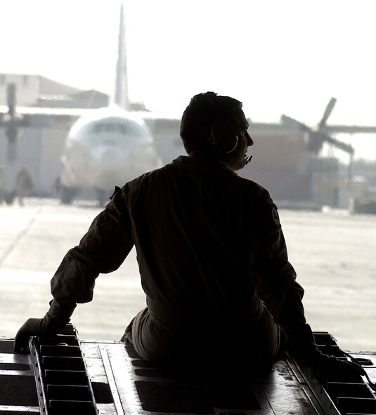 Staff Sgt. David Shively, C-130 loadmaster, sits on the ramp of a C-130 Hercules as it taxis to a parking spot at Kabul International Airport, Afghanistan, Aug. 4.  Sergeant Shively is deployed to the 774th Expeditionary Airlift Squadron at Bagram Airfield, Afghanistan, in support of Operation Enduring Freedom.  He is from the Tennessee Air National Guard.  Hercules cargo aircraft deliver troops and supplies throughout Afghanistan in support of U.S. and Coalition Forces.  The C-130 crews from the 774th EAS also conduct airdrops of supplies to units based throughout Afghanistan on a scale not seen since the Vietnam War.  (US Air Force photo/Maj. David Kurle)