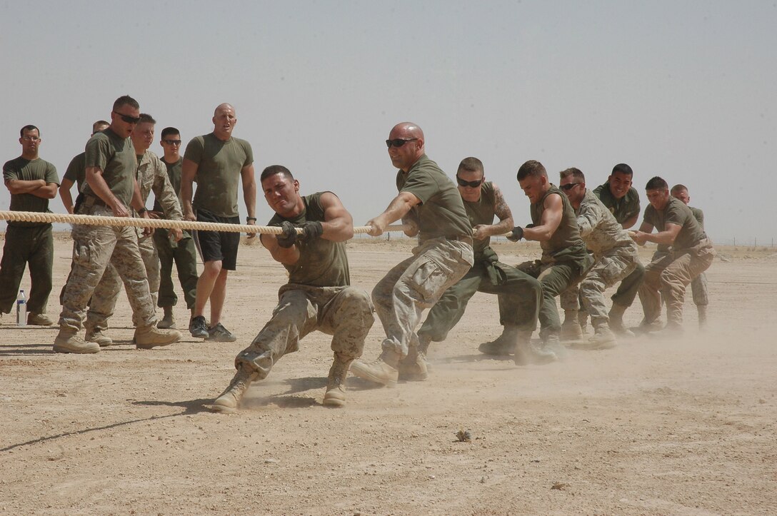 Marines from Marine Attack Squadron 513, Marine Aircraft Group 16 (Reinforced), 3rd Marine Aircraft Wing, compete in a tug-of-war Aug. 6, at Al Asad, Iraq. The tug-of-war was just one event at the field meet. The Marines also had a barbeque and music, adding to the morale-boosting excitement of the day.