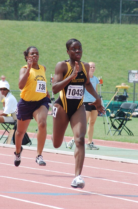 Sergeant Lisa Rosborough sprints past the competition in the 200 meter dash during her run for three Gold medals in the 30-34 year old division of the Masters Outdoor Championships.