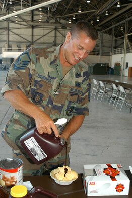 GRISSOM AIR RESERVE BASE, Ind -- Master Sgt. Darin Schenher, 434th Aircraft Maintenance Squadron production supervisor, pours chocolate syrup over his vanilla ice cream during this years ice-cream social. The event is one of several fundraisers that support the holiday party given by the 434th Maintenance Group. The event also gave Airmen the chance to cool down during the recent heat wave across the Midwest. (U.S. Air Force photo/SrA. Mark Orders-Woempner)