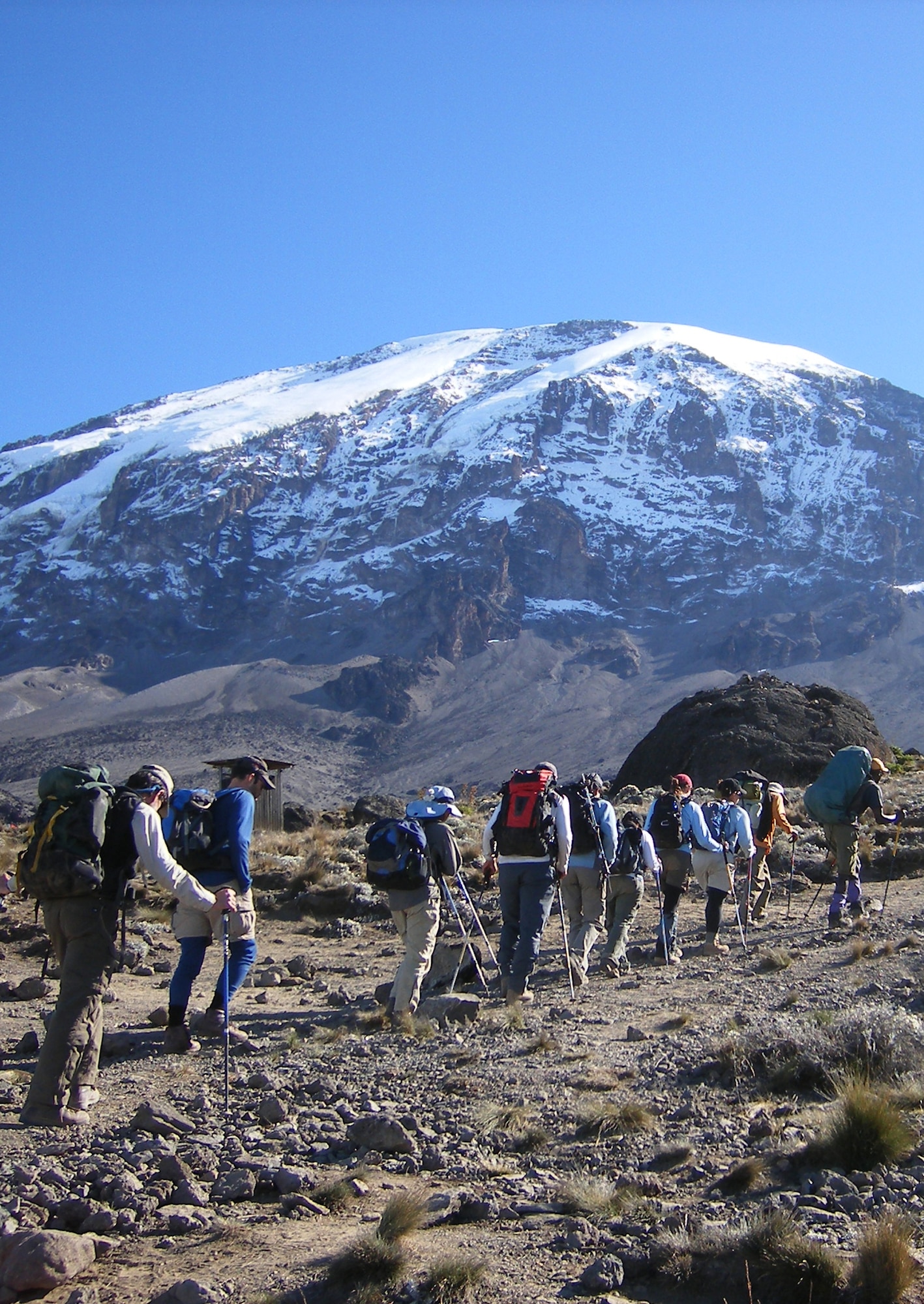Led by their guide, Emmanuel, the "Seven Summits Challenge" Air Force team hike towards the summit of Mount Kilimanjaro July 12 on the third day of their journey. The challenge is a quest to scale the tallest peaks on all seven continents.  The team has five more peaks to climb.  (U.S. Air Force photo by Capt. Rob Marshall)