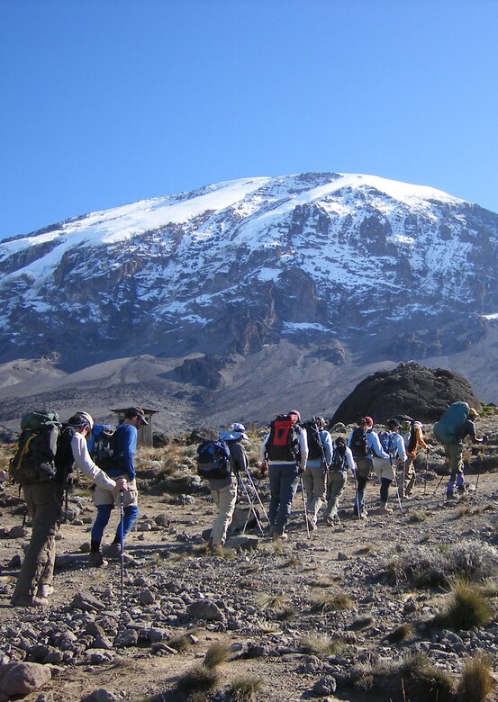 Led by their guide, Emmanuel, the "Seven Summits Challenge" Air Force team hike towards the summit of Mount Kilimanjaro July 12 on the third day of their journey. The challenge is a quest to scale the tallest peaks on all seven continents.  The team has five more peaks to climb.  (U.S. Air Force photo by Capt. Rob Marshall)
