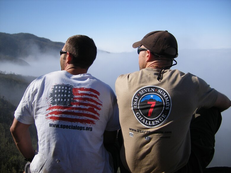 1st Lt. Mark Uberuaga, left, and Capt. Rob Marshall gaze upwards toward the summit of Mount Kilimanjaro during a break on day two of their ascent. The two were part of an Air Force team which scaled the African peak July 16.  (U.S. Air Force photo by Capt. Nichelle Brokering)