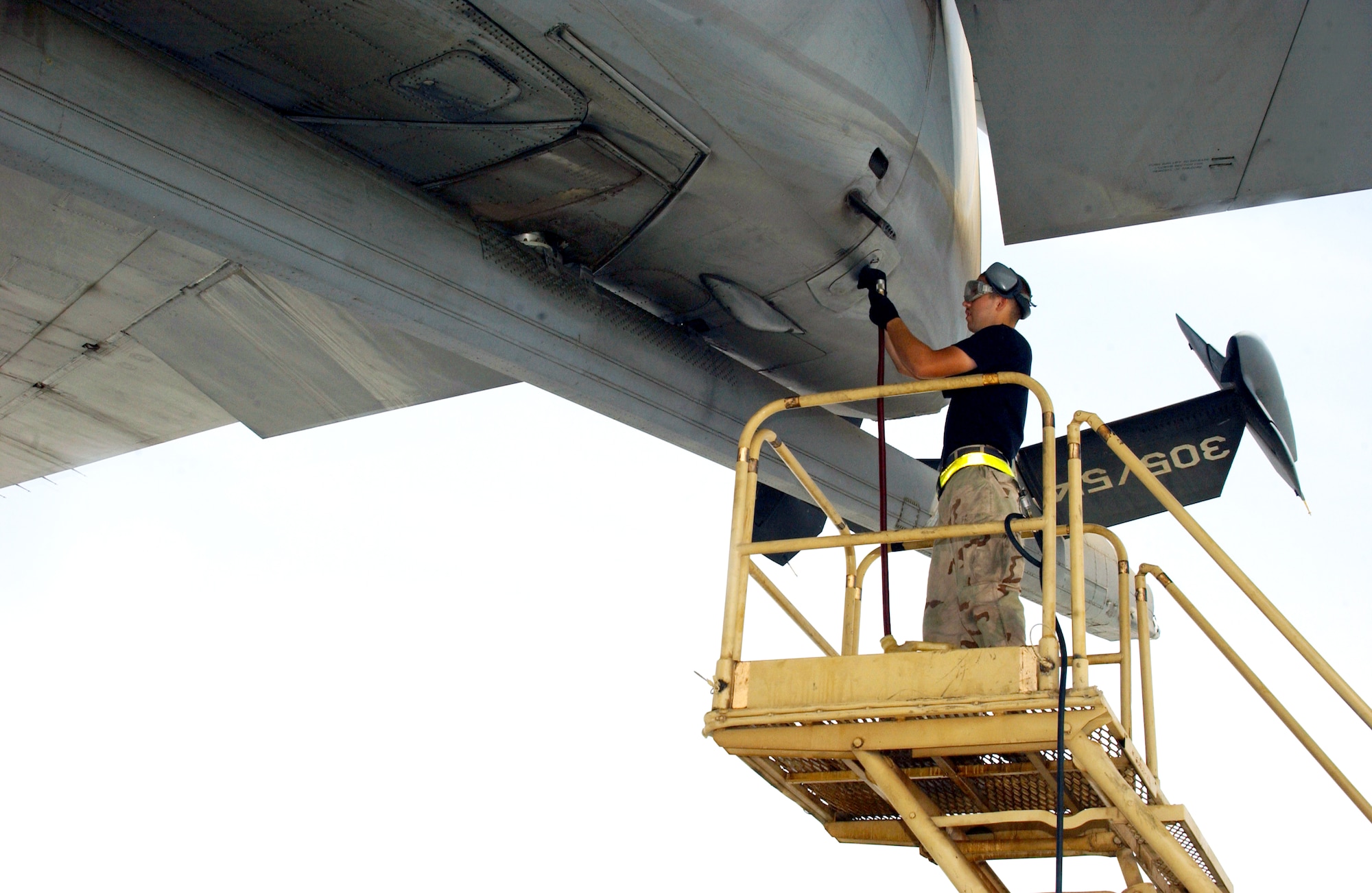 Airman Nicholas Shoenhair services an engine on a KC-10 Extender with the 908th Expeditionary Air Refueling Wing at a deployed location in Southwest Asia on July 30. Airman Shoenhair is a KC-10 crew chief with the 380th Expeditionary Aircraft Maintenance Squadron. (U.S. Air Force photo/Staff Sgt. Jason Webb)