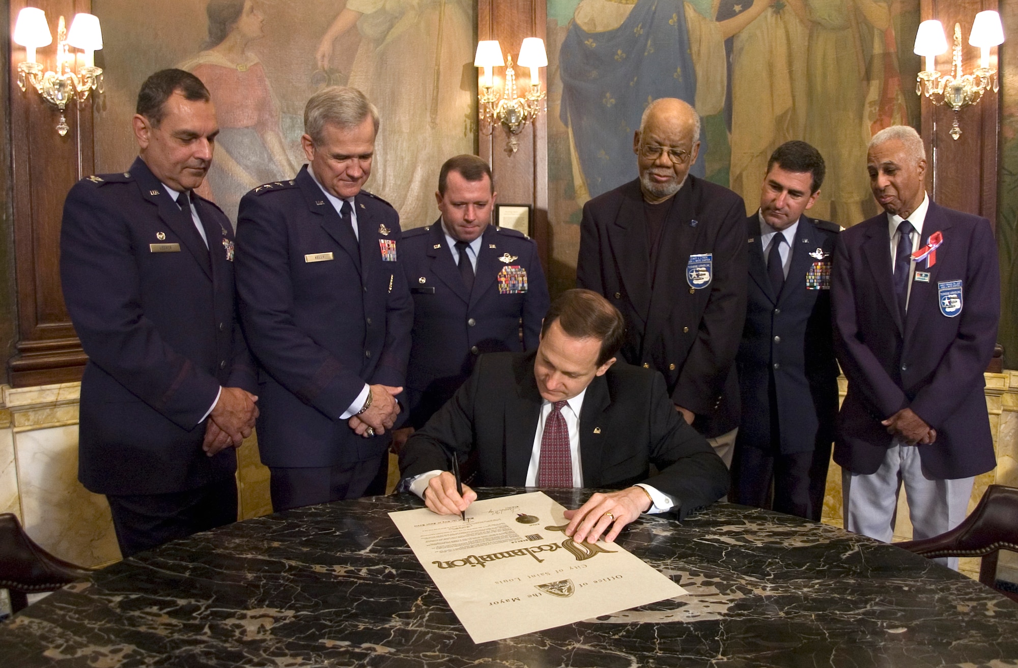 St. Louis Mayor Francis G. Slay signs a proclamation today declaring Aug. 6-13 as Air Force Week in St. Louis. Attending the ceremony were (from left) Col. Bob Leeker, 131st Fighter Wing commander; Lt. Gen. Christopher A. Kelly, Air Mobility Command vice commander; Col. Allen Hunt Jr., 375th Airlift Wing commander; Lewis Lynch, Hugh J. White Chapter of the Tuskegee Airmen; Col. Pete Nezamis, 126th Air Refueling Wing commander; and retired Col. John P. Morgan, Hugh J. White Chapter of the Tuskegee Airmen. (U.S. Air Force photo/Master Sgt. Jack Braden)