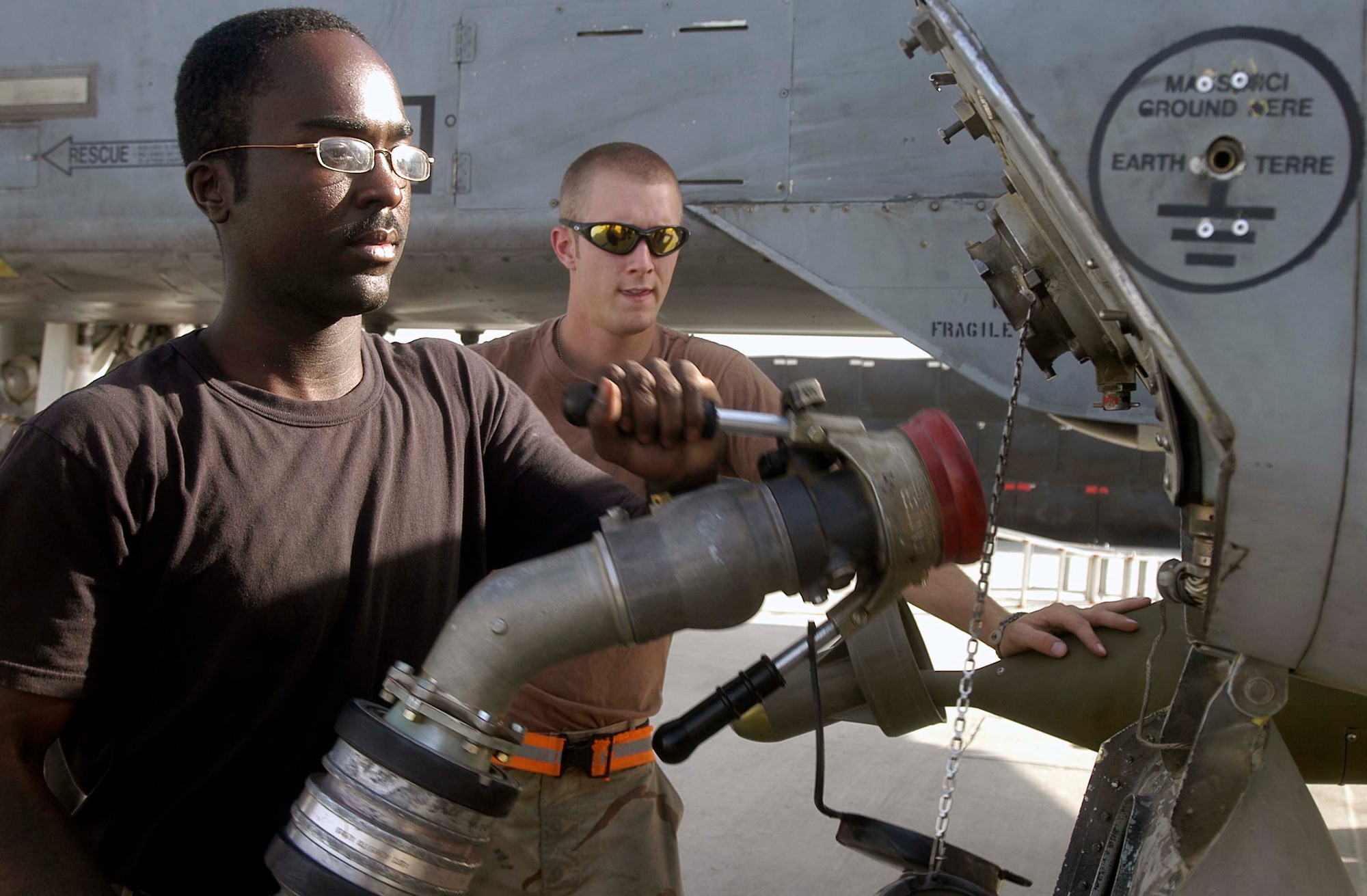 Airman 1st Class Christopher Leach attaches a fuel hose from a tanker truck to an A-10 Thunderbolt II at Bagram Air Base, Afghanistan, on Aug. 5, as crew chief Airman 1st Class Perry Friend watches. Airman Leach has pumped more than 1 million gallons of jet fuel during his four-month air expeditionary force rotation. The 455th Expeditionary Logistics Readiness Squadron Petroleum, Lubricants and Oil Flight has delivered almost 6.6 million gallons of fuel to military and civilian aircraft at Bagram since early May. Airman Leach, deployed from Dover Air Force Base, Del. (U.S. Air Force photo/Maj. David Kurle) 