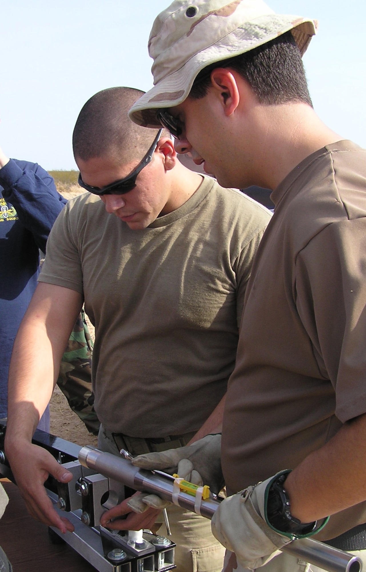 Tech. Sgt. Tom Kiser and Senior Airman Ruel Espinosa, 944th Fighter Wing explosive ordnance disposal team members, set up a disruptive device at the Barry M. Goldwater Range. (U.S. Air Force photo/Teresa Walker)