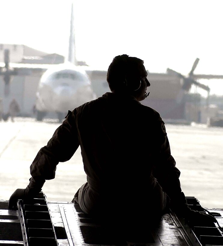 Staff Sgt. David Shively sits on the ramp of a C-130 Hercules as it taxis to a parking spot at the Kabul International Airport, Afghanistan, on Aug. 4. Sergeant Shively is deployed to the 774th Expeditionary Airlift Squadron at Bagram Air Base, Afghanistan, in support of Operation Enduring Freedom. He is a C-130 loadmaster from the Tennessee Air National Guard. Hercules cargo aircraft deliver troops and supplies throughout Afghanistan in support of U.S. and coalition forces. (U.S. Air Force photo/Maj. David Kurle)