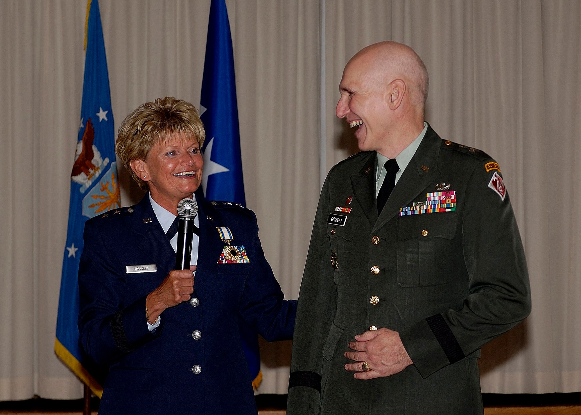 Maj Gen Elizabeth A. Harrell, Director of Maintenance and Logistics, Air Combat Command, shares a moment with her fiance, Maj Gen William Grisoldi, Commander, US Army Corps of Engineers, during her retirement ceremony.  Maj Gen Harrell is retiring after 30 years of service.  (USAF photo by TSgt Elizabeth Weinberg)  