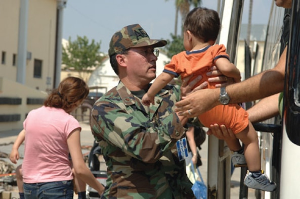 Chaplain (Maj.) Kenneth Reyes,39th Air Base Wing senior chaplain, helps unload displaced American citizen’s from Lebanon Monday. Incirlik received more than 1,700 departing American’s July 22.


