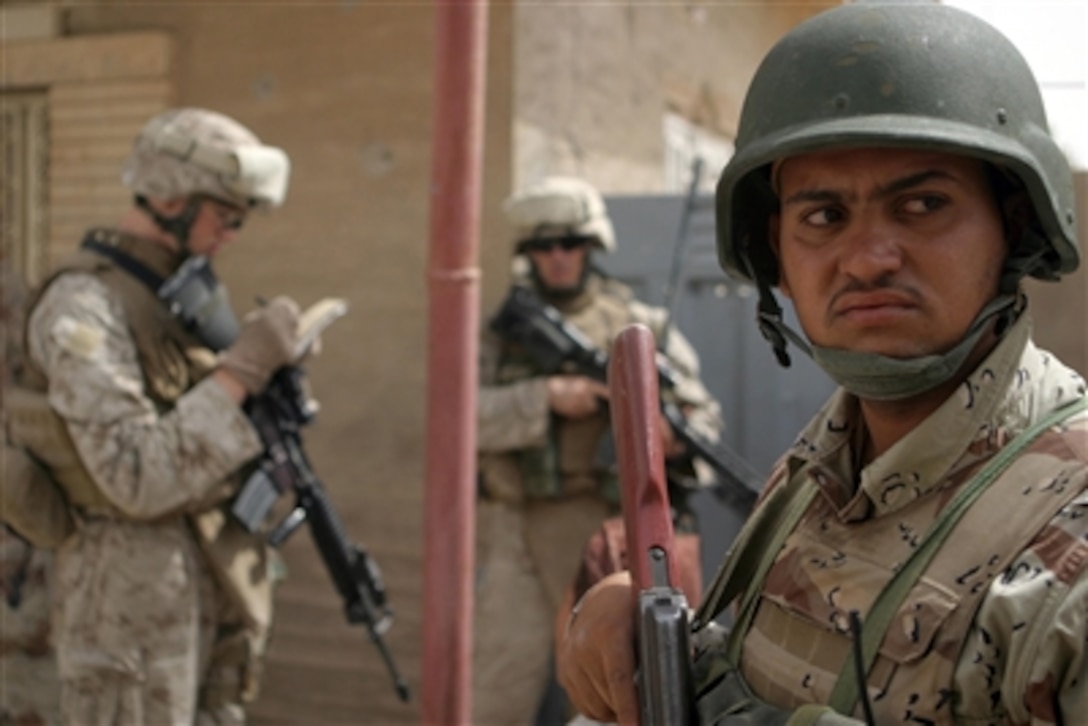 U.S. Marines and Iraqi army soldiers conduct a joint patrol in Barwanah, Iraq, on July 30, 2006.  The Marines are attached to Lima Company, 3rd Battalion, 3rd Marine Regiment, Regimental Combat Team 7, I Marine Expeditionary Force (Forward).  