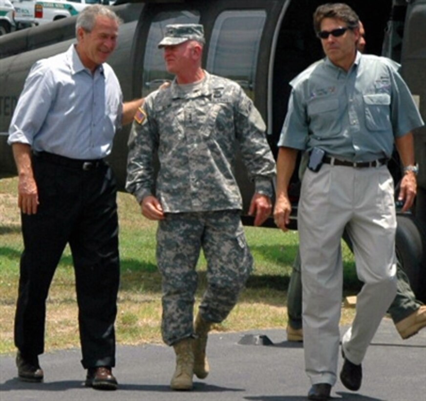 President George W. Bush, left, is greeted by U.S. Army Lt. Gen. H. Steven Blum, chief of the National Guard Bureau, center, and Texas Gov. Rick Perry at the McAllen-Miller International Airport in McAllen, Texas, Aug. 3, 2006. Bush visited National Guard troops participating in Operation Jump Start. 