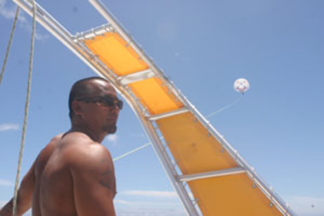 Tony SucSuico, boat crewman for X-Treme Parasail in Waikiki, looks asks passengers on his parasailing boat if they are ready for their turn to glide up in the sky next.