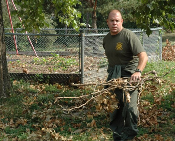 Petty Officer 1st Class Lawrence E. Pieper, religious programs specialist, Chemical, Biological Incident Response Force, II Marine Expeditionary Force, helps clean up the grounds of St. Vincent Home, St. Louis, for Children, Aug. 7. A product of Missouri?s foster care system, Pieper was key in coordinating this project took take place while CBIRF was participating in an multi-agency exercise in the area.