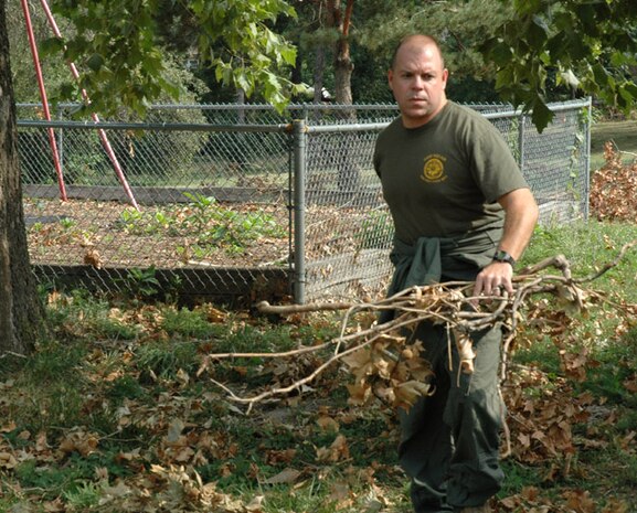 Petty Officer 1st Class Lawrence E. Pieper, religious programs specialist, Chemical, Biological Incident Response Force, II Marine Expeditionary Force, helps clean up the grounds of St. Vincent Home, St. Louis, for Children, Aug. 7. A product of Missouri?s foster care system, Pieper was key in coordinating this project took take place while CBIRF was participating in an multi-agency exercise in the area.