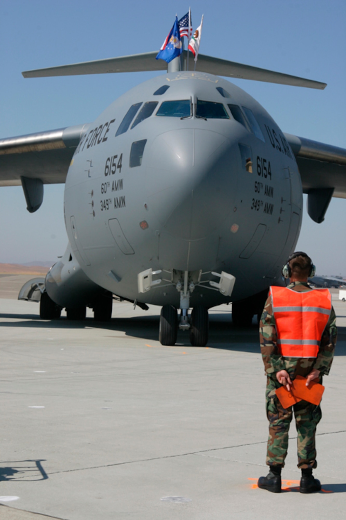 Travis Air Force Base first C-17 "Spirit of Solano" is marshaled in for the arrival ceremony on Travis AFB flightline Aug. 8. This is the first of 13 C-17s that Travis AFB will recieve, adding its tactical capabilities to Travis' mission. (U.S. Air Force photo/Master Sgt. Wendy Weidenhamer)
