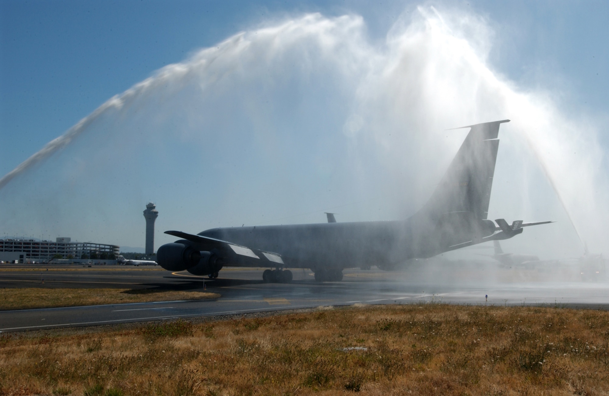 An Air Force Reserve  KC-135R taxis through a water arch on the flight line at Portland International Airport on Aug. 5, 2006.  The tankers left Oregon for another Reserve unit near Oklahoma City, Okla. as part of the Base Realignment and Closure process.  (U.S. Air Force Photo/Staff Sgt. Jorge A. Rodriguez)