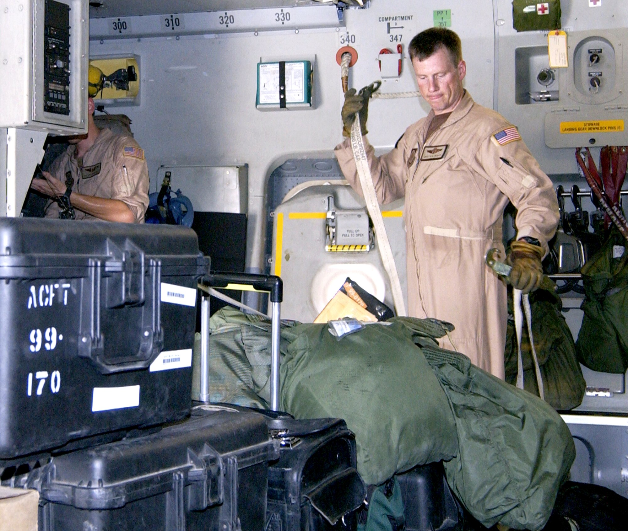 Master Sgt. Bryan Beaty prepares cargo before takeoff at a forward operating base in Southwest Asia on Aug. 5. Sergeant Beaty is a C-17 Globemaster III loadmaster with the 816th Expeditionary Airlift Squadron. (U.S. Air Force photo/Staff Sgt. Paul J. Gonzalez)
