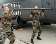 MOFFETT FEDERAL AIRFIELD, Calif. -- Air Force Reserve Technical Sergeants Paul Tatar, left, and Tom Kocis, aerial spray maintenenace technicians with Air Force Reserve Command's 910th Airlift Wing, Youngstown Air Reserve Station, Ohio prepare a boom nozzle configuration for a specially-modified C-130H aircraft in support of the Safe Seas 2006 Oil Spill Response Exercise to be held in San Francisco August 9.  U.S. Air Force photo/Capt. Brent Davis.
