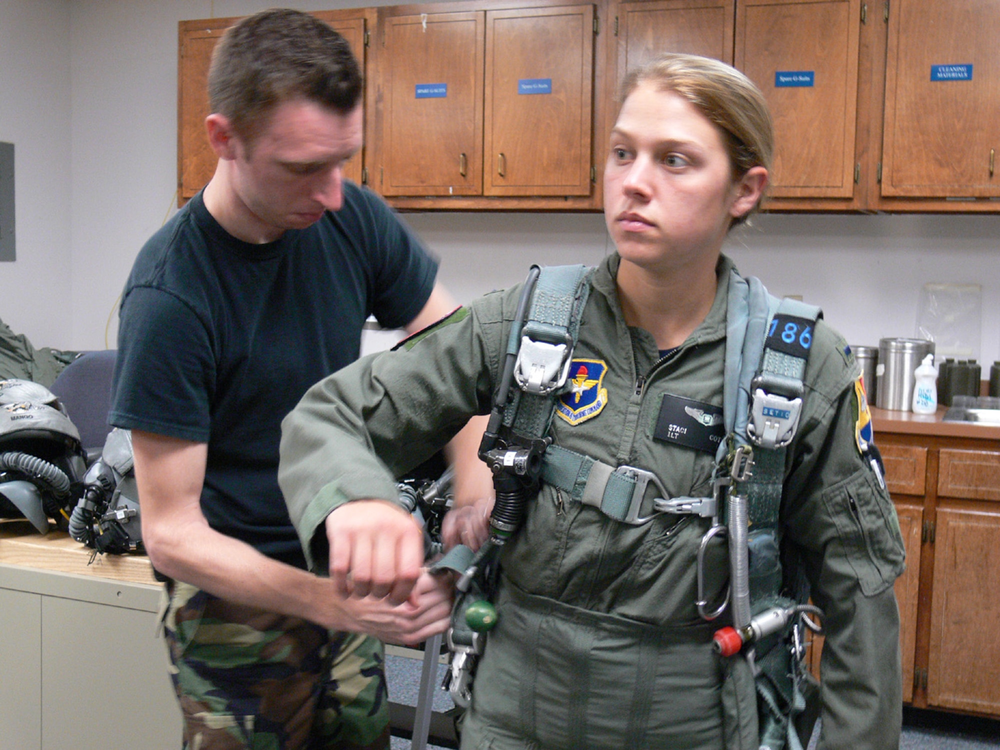 MOODY AIR FORCE BASE, Ga. -- Senior Airman Tom Gibson, 479th Operations Support Squadron aircrew life support technician, adjusts the sling on 1st Lt. Staci Cotner, 435th Fighter Training Squadron AT-38C Introduction to Fighter Fundamentals Undergraduate Weapons Systems Operator, Friday. Airman Gibson makes sure the parachute properly fits so the pilot will not fall out of the harness. (USAF photo by Senior Airman S.I. Fielder)
